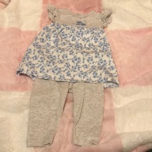 white with blue flowers shirt with grey pants.